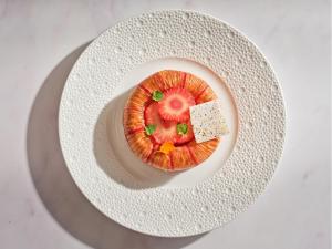a plate with a piece of food on a table at Sofitel London St James in London +51 photos