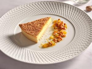 a white plate with a piece of cake and beans at Sofitel London St James in London