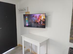 a white table with a tv on a wall at Dorado Stey 2 in Río Grande