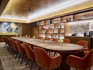 a conference room with a large table and chairs at Sofitel London St James in London
