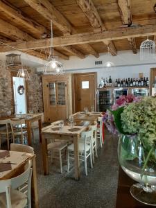 a dining room with wooden tables and white chairs at Osteria Al Ponte in Udine