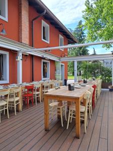 a wooden deck with tables and chairs on a building at Osteria Al Ponte in Udine