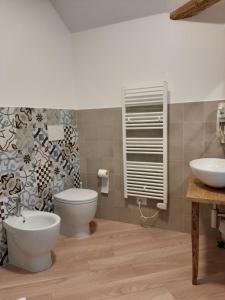 a bathroom with a toilet and a sink at Osteria Al Ponte in Udine +14 photos