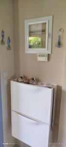 a refrigerator in a kitchen with a microwave above it at Zach's house in Nea Roda +69 photos