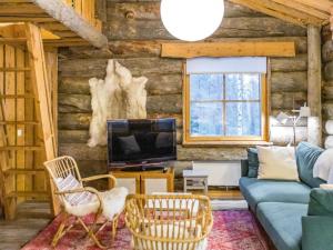 a living room with a couch and a tv at Holiday Home Luppokero 3 by Interhome in Pyhätunturi