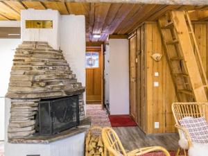 a living room with a stone fireplace in a house at Holiday Home Luppokero 3 by Interhome in Pyhätunturi