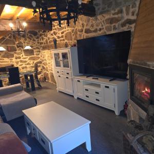 a living room with a tv and a fireplace at casa cristimil -san amaro in Salamonde