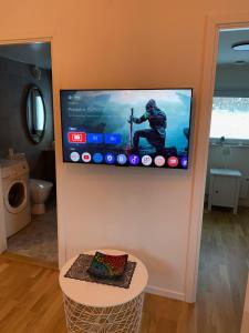 a television on a wall in a room at Stuga Marsi in Ystad