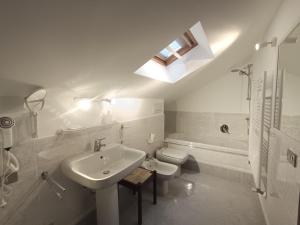 a white bathroom with a sink and a toilet at Suite Dream in Stresa +13 photos