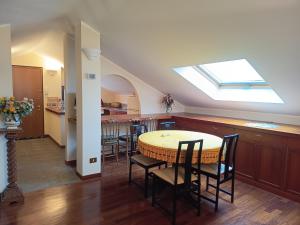 a kitchen with a table and chairs and a skylight at Suite Dream in Stresa