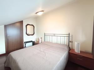 a bedroom with a bed and a dresser and a mirror at Suite Dream in Stresa