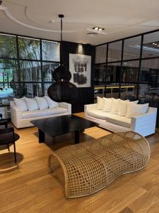 a living room with white couches and a table at THE HOTEL in Córdoba