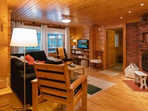 a living room with a couch and a table at Holiday Home Kuusenkolo by Interhome in Pyhätunturi