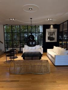 a living room with two white couches and a rug at THE HOTEL in Córdoba