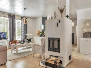 a living room with a fireplace in the middle at Holiday Home Huvikumpu by Interhome in Hailuoto