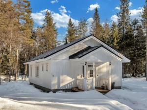 a white garage with snow on the ground at Holiday Home Huvikumpu by Interhome in Hailuoto +20 photos