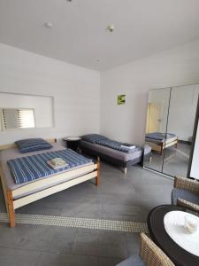 a bedroom with two beds and a mirror at Ferienwohnung-Monteurwohnung-Parkplatz in Meine +6 photos