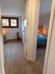 a room with a bedroom with a bed and a window at La Caseta del Ter in San Juan de Mollet