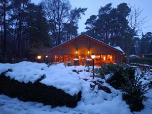 a cabin in the snow at night at Het Vijverhuisje - Holiday only in Doornspijk