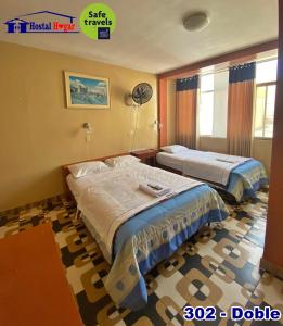 a hotel room with two beds and a window at HOSTAL HOGAR 3 Estrellas - CHEPÉN in Chepén +30 photos
