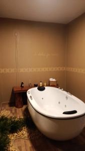 a large white bath tub in a bathroom at Vinhas das Grutas in Soledade