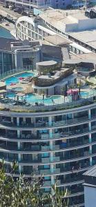 an overhead view of a large building with a swimming pool at Gibraltar Luxe Stay in Gibraltar