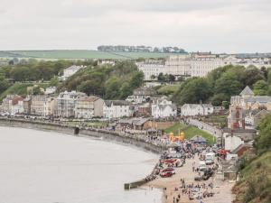 a group of people on a beach near the water at Rutland Grange in Filey