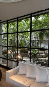 a white couch in a room with large windows at THE HOTEL in Córdoba