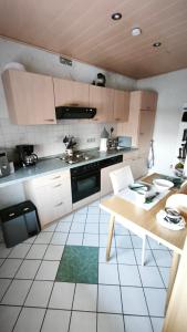a kitchen with a table and a counter top at Gästewohnung Urfttalsperre in Schleiden