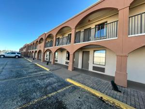 a parking lot in front of a building at Suite Dreams Hotel in Mattoon