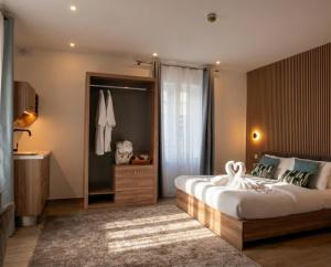 a bedroom with a large bed and a bathroom at Kappuccini Hill boutique hotel - By Tritoni Hotels in Il-Furjana