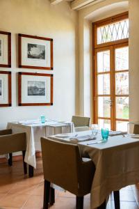 a dining room with tables and chairs and a window at Villa Arcadio in Salò