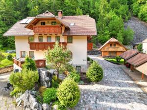 an aerial view of a house in the mountains at Apartma in Bungalov Jezerci in Gozd Martuljek