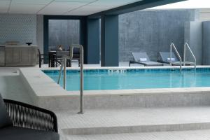a large swimming pool with chairs and a table at Mint House Tampa Downtown by Kasa in Tampa