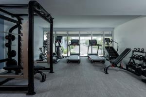 a gym with several treadmills and elliptical machines at Mint House Tampa Downtown by Kasa in Tampa