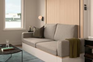 a living room with a couch and a table at Mint House Tampa Downtown by Kasa in Tampa
