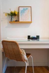 a desk with a wicker chair in front of a table at Chambre 3 La Madalena in Nice