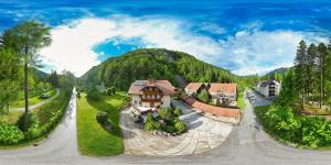 an aerial view of a house in the mountains at Apartma in Bungalov Jezerci in Gozd Martuljek