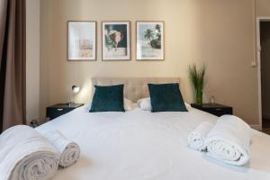 a bedroom with a white bed with towels on it at Chambre 3 La Madalena in Nice