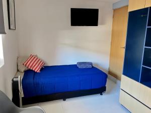 a bedroom with a blue bed in a room at Living Alameda in Querétaro