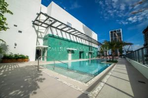 a swimming pool in front of a building at Crosby Miami World Center in Miami