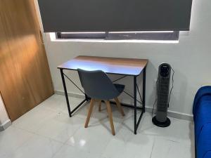 a table and a chair in a room at Living Alameda in Querétaro