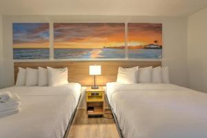 two beds sitting next to each other in a room at Hotel Carolina in Hilton Head Island
