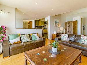 a living room with two couches and a coffee table at 5 Suikerbossie in Gordonʼs Bay