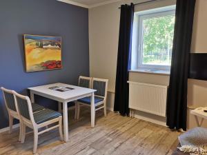 a dining room with a table and chairs and a window at 11 Haselnuss - Hof Wiesengrund in Parchtitz