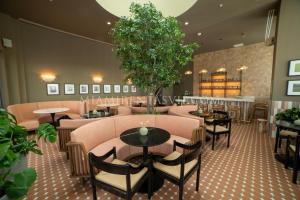 a restaurant with tables and chairs and a bar at Crosby Miami World Center in Miami