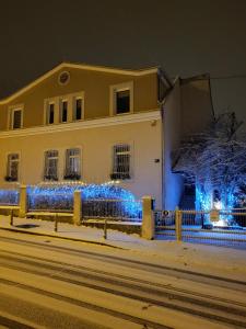 a house decorated with blue lights in the snow at Villa Vino & Grad in Zagreb +144 photos