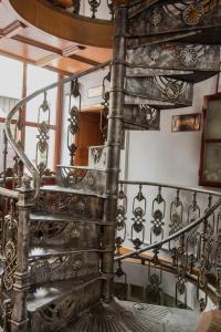 a spiral staircase in a building with a metal railing at Hotel Ovo malo duše in Sarajevo