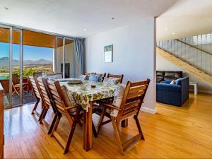 a dining room with a table and some chairs at 5 Suikerbossie in Gordonʼs Bay