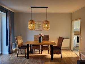 a dining room with a table with chairs and lights at 10 Walnuss - Hof Wiesengrund in Parchtitz